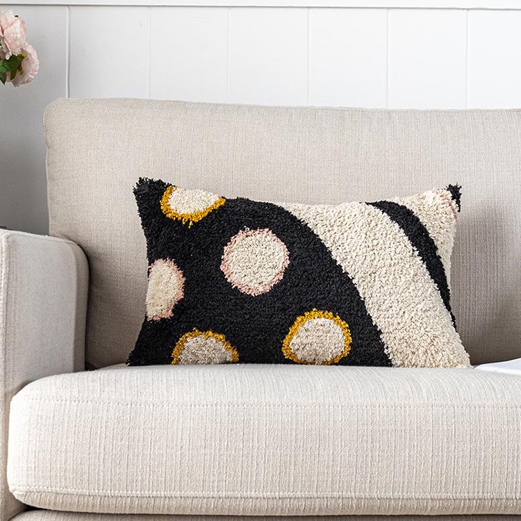 Circled Mod Pillow on couch 